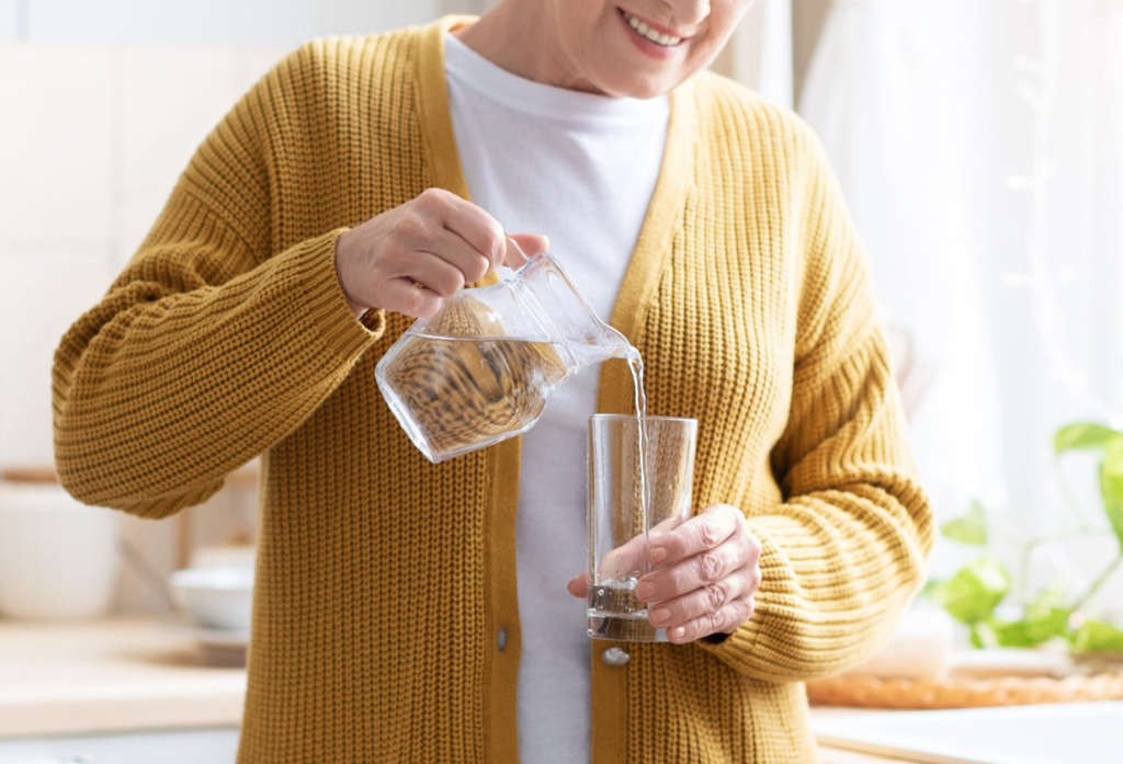 Pouring a glass of clean alkaline water at home